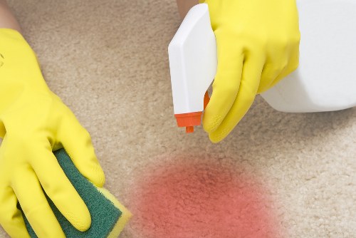 Worker using protective gear during carpet cleaning operations