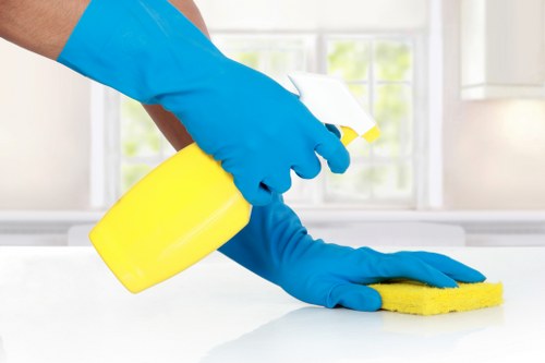 Cleaners preparing carpet cleaning equipment with safety checks in place